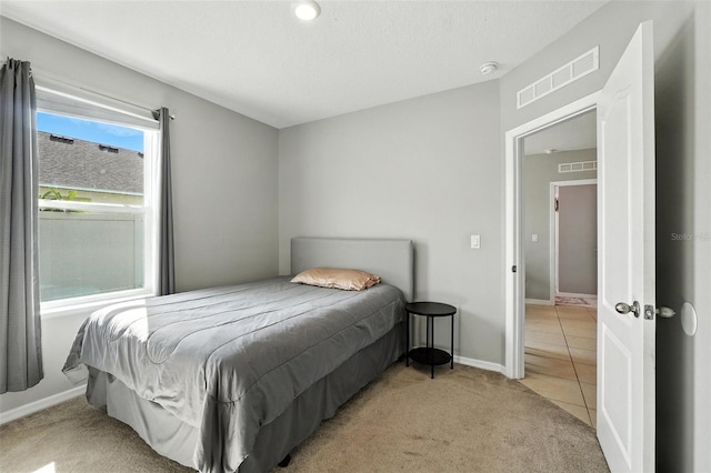 303 Briarbrook Ln, Haines City, FL 33844 - bedroom with light carpet and light tile patterned floors