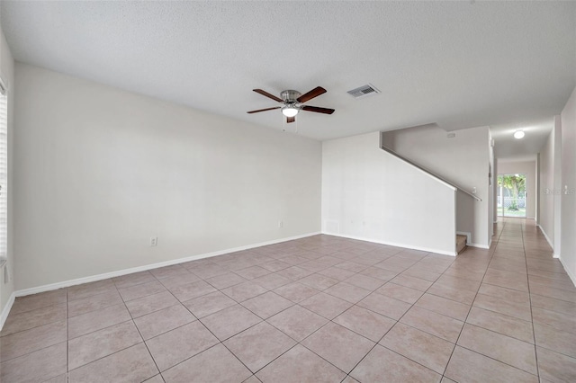 1302 Twilridge Pl, Brandon, FL 33511 - unfurnished room featuring a ceiling fan, light tile patterned flooring, a textured ceiling, and stairs