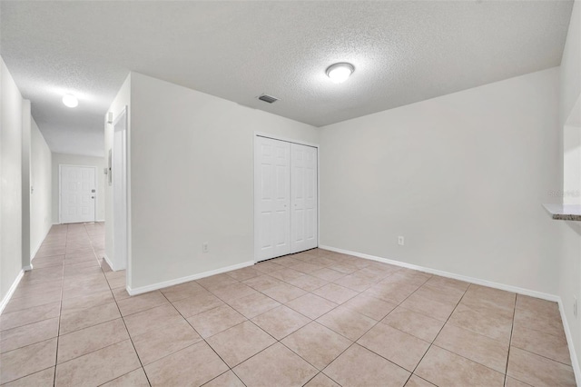 1302 Twilridge Pl, Brandon, FL 33511 - unfurnished bedroom with a textured ceiling, light tile patterned floors, and a closet
