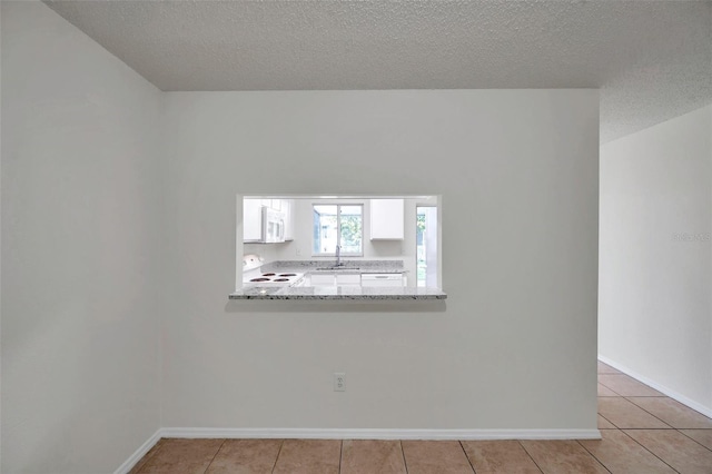 1302 Twilridge Pl, Brandon, FL 33511 - empty room with light tile patterned floors and a textured ceiling