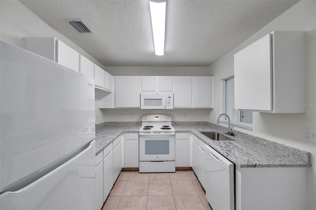 1302 Twilridge Pl, Brandon, FL 33511 - kitchen featuring white appliances, white cabinetry, a textured ceiling, light tile patterned floors, and light stone countertops
