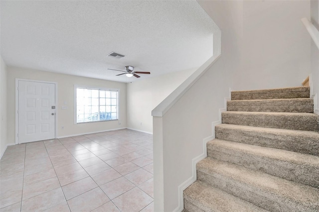 1302 Twilridge Pl, Brandon, FL 33511 - entryway featuring stairway, ceiling fan, light tile patterned floors, and a textured ceiling