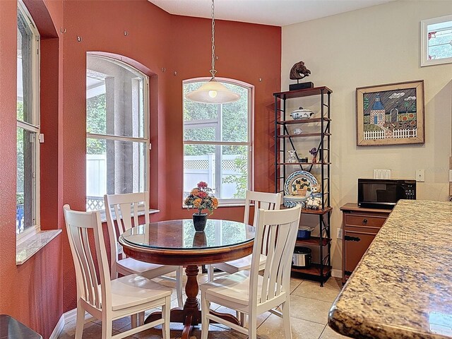 12200 Hunters Lake Dr, New Port Richey, FL 34654 - dining space with healthy amount of natural light and light tile patterned floors