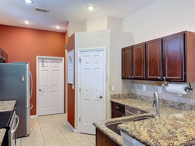 12200 Hunters Lake Dr, New Port Richey, FL 34654 - kitchen featuring light tile patterned flooring, appliances with stainless steel finishes, stone counters, tasteful backsplash, and a peninsula