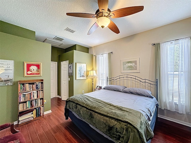 12200 Hunters Lake Dr, New Port Richey, FL 34654 - bedroom featuring wood finished floors, multiple windows, a ceiling fan, and a textured ceiling