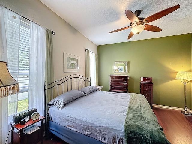 12200 Hunters Lake Dr, New Port Richey, FL 34654 - bedroom with wood finished floors, a textured ceiling, and a ceiling fan