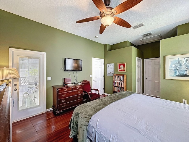 12200 Hunters Lake Dr, New Port Richey, FL 34654 - bedroom featuring dark wood-type flooring, a textured ceiling, access to outside, and a ceiling fan