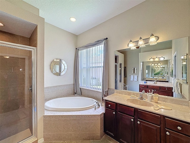12200 Hunters Lake Dr, New Port Richey, FL 34654 - bathroom with a bath, a shower stall, vanity, a textured ceiling, and tile patterned floors