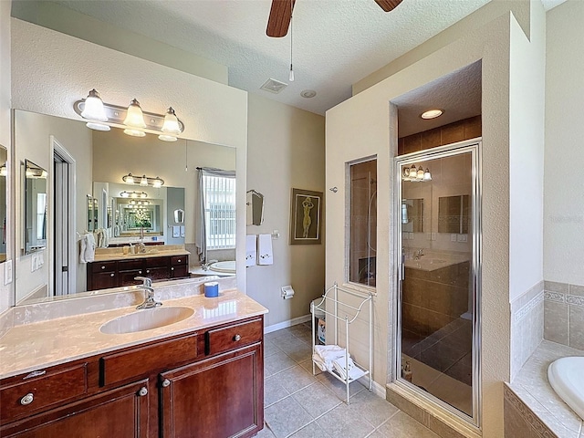 12200 Hunters Lake Dr, New Port Richey, FL 34654 - full bathroom featuring a ceiling fan, a bath, a shower stall, vanity, and tile patterned flooring