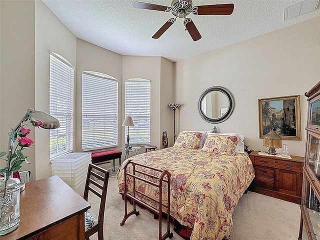 12200 Hunters Lake Dr, New Port Richey, FL 34654 - bedroom featuring light carpet, a textured ceiling, and a ceiling fan