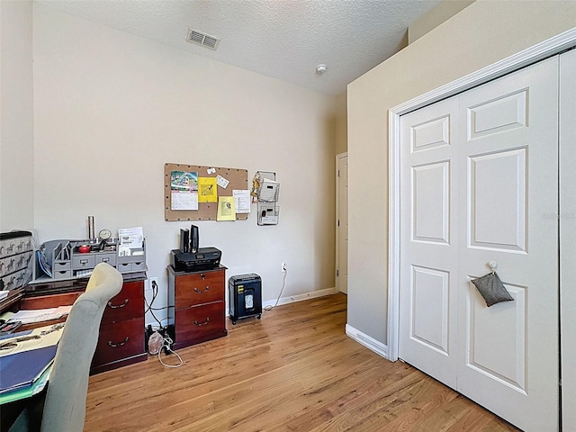 12200 Hunters Lake Dr, New Port Richey, FL 34654 - office area featuring light wood-style flooring and a textured ceiling