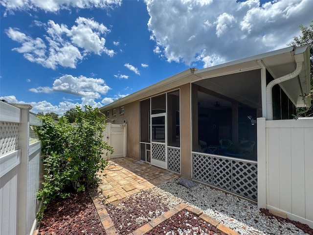 12200 Hunters Lake Dr, New Port Richey, FL 34654 - view of patio / terrace featuring a sunroom and a gate