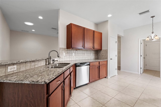 11144 Paradise Point Way, New Port Richey, FL 34654 - kitchen with stainless steel dishwasher, light stone counters, decorative backsplash, a chandelier, and pendant lighting