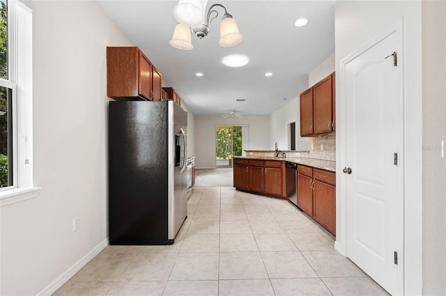 11144 Paradise Point Way, New Port Richey, FL 34654 - kitchen featuring appliances with stainless steel finishes, a peninsula, ceiling fan, light tile patterned floors, and a chandelier