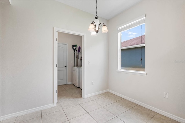11144 Paradise Point Way, New Port Richey, FL 34654 - empty room with independent washer and dryer, a chandelier, and light tile patterned floors