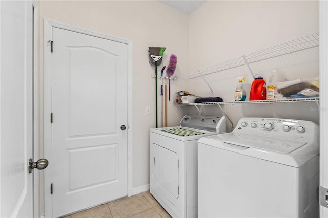 11144 Paradise Point Way, New Port Richey, FL 34654 - laundry area with washer and dryer and light tile patterned flooring