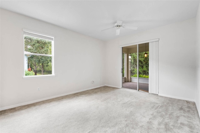 11144 Paradise Point Way, New Port Richey, FL 34654 - carpeted empty room featuring healthy amount of natural light and ceiling fan