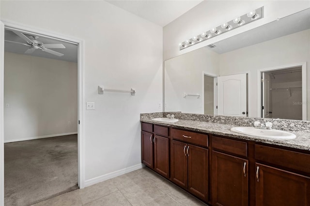 11144 Paradise Point Way, New Port Richey, FL 34654 - full bathroom featuring double vanity, a ceiling fan, a spacious closet, and tile patterned floors