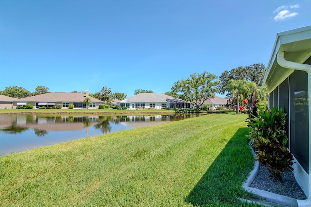 717 Manchester Woods Dr Unit 717, Sun City Center, FL 33573 - view of green lawn featuring a water view and a residential view