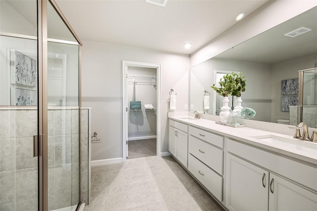 1128 Creek Valley Ct, Brandon, FL 33511 - full bathroom featuring double vanity, a stall shower, a walk in closet, tile patterned floors, and recessed lighting