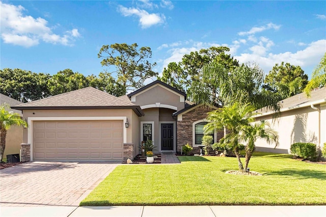 5264 Brilliance Cir, Cocoa, FL 32926 - view of front facade with stucco siding, stone siding, an attached garage, decorative driveway, and a front lawn