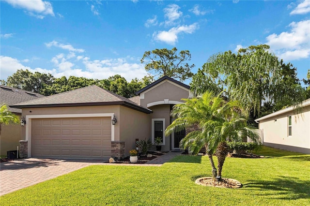 5264 Brilliance Cir, Cocoa, FL 32926 - view of front of home featuring stucco siding, an attached garage, a front yard, driveway, and roof with shingles