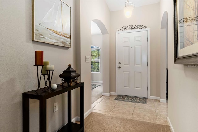 5264 Brilliance Cir, Cocoa, FL 32926 - foyer featuring arched walkways, light colored carpet, and light tile patterned floors