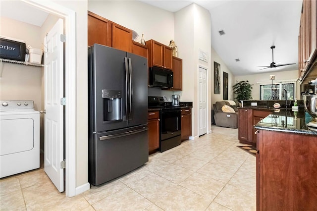 5264 Brilliance Cir, Cocoa, FL 32926 - kitchen with black appliances, washer / dryer, lofted ceiling, light tile patterned floors, and a ceiling fan
