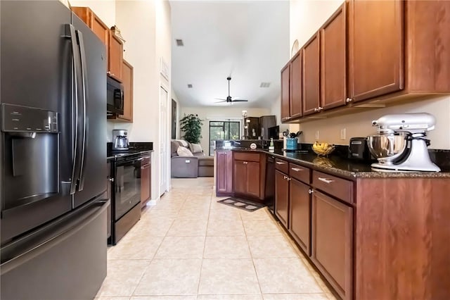 5264 Brilliance Cir, Cocoa, FL 32926 - kitchen with black appliances, open floor plan, light tile patterned floors, ceiling fan, and brown cabinetry