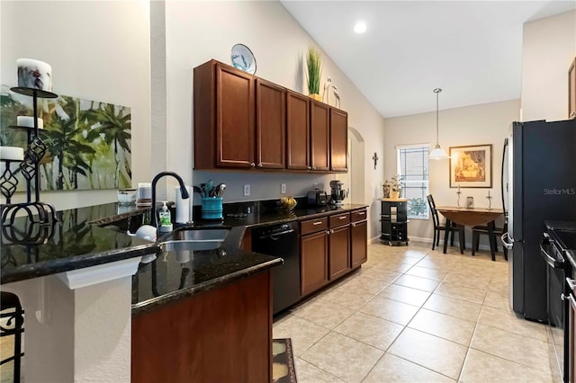 5264 Brilliance Cir, Cocoa, FL 32926 - kitchen featuring dishwashing machine, freestanding refrigerator, a kitchen bar, decorative light fixtures, and high vaulted ceiling