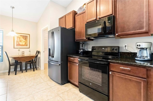 5264 Brilliance Cir, Cocoa, FL 32926 - kitchen with black appliances, lofted ceiling, light tile patterned floors, dark stone counters, and decorative light fixtures