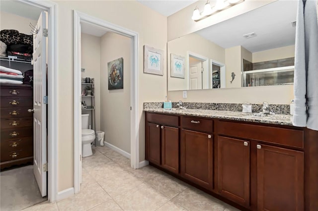 5264 Brilliance Cir, Cocoa, FL 32926 - bathroom with double vanity, tile patterned floors, a stall shower, and a walk in closet