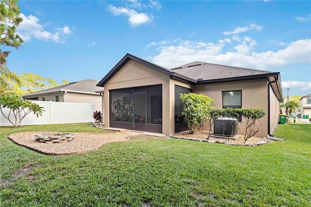 5264 Brilliance Cir, Cocoa, FL 32926 - back of property featuring a sunroom, stucco siding, an outdoor fire pit, and a shingled roof