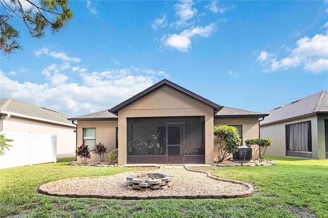 5264 Brilliance Cir, Cocoa, FL 32926 - rear view of house featuring an outdoor fire pit, a sunroom, and stucco siding