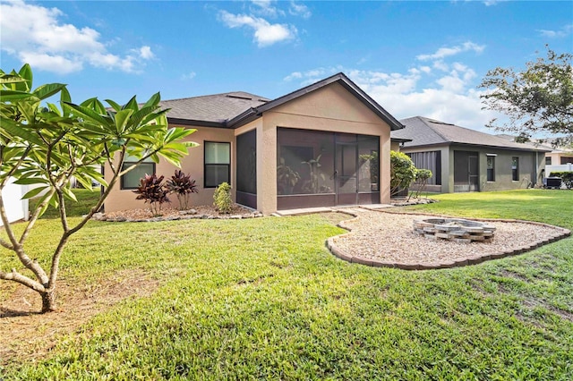 5264 Brilliance Cir, Cocoa, FL 32926 - rear view of property with a sunroom, stucco siding, an outdoor fire pit, and a lawn