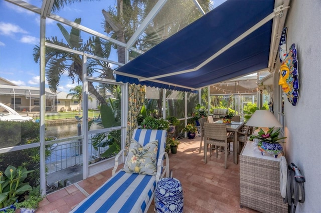 4743 Spinnaker Dr, Bradenton, FL 34208 - sunroom / solarium with outdoor dining space and a water view
