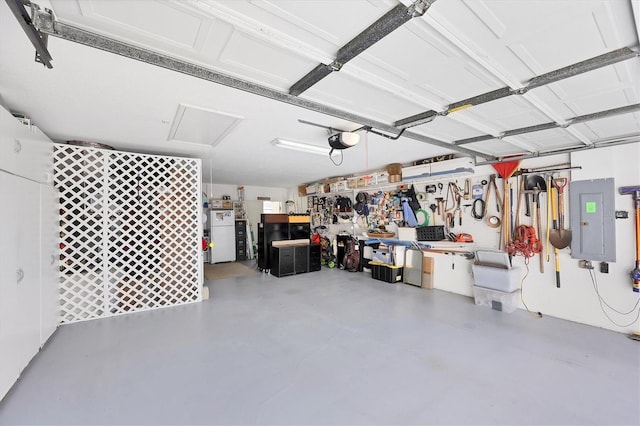 4743 Spinnaker Dr, Bradenton, FL 34208 - garage featuring a garage door opener, electric panel, a workshop area, and freestanding refrigerator