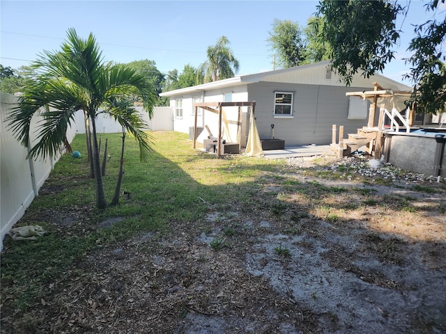 310 4th Ave SW, Ruskin, FL 33570 - rear view of property with a fenced backyard