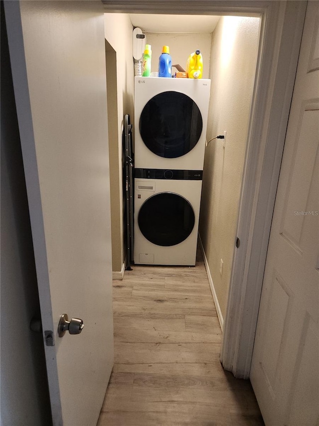 310 4th Ave SW, Ruskin, FL 33570 - laundry area featuring stacked washer / drying machine and light wood-style flooring