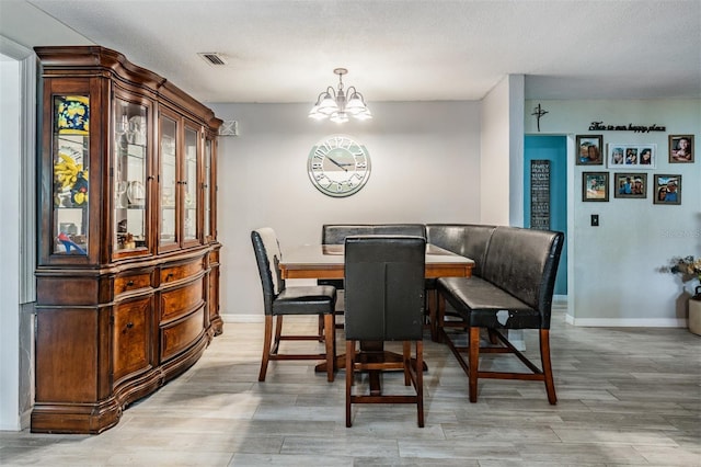1403 Tallahassee Dr, Tarpon Springs, FL 34689 - dining space with a chandelier and light wood-style floors