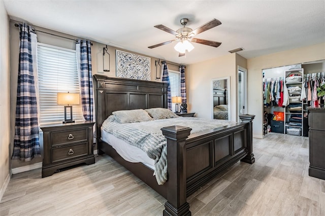 1403 Tallahassee Dr, Tarpon Springs, FL 34689 - bedroom with a walk in closet, light wood finished floors, a closet, and a ceiling fan