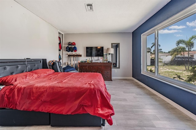 1403 Tallahassee Dr, Tarpon Springs, FL 34689 - bedroom featuring wood finished floors and a textured ceiling