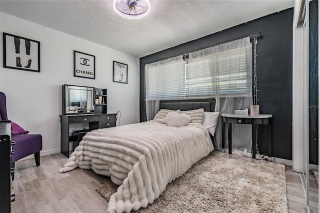 1403 Tallahassee Dr, Tarpon Springs, FL 34689 - bedroom featuring wood finished floors and a textured ceiling