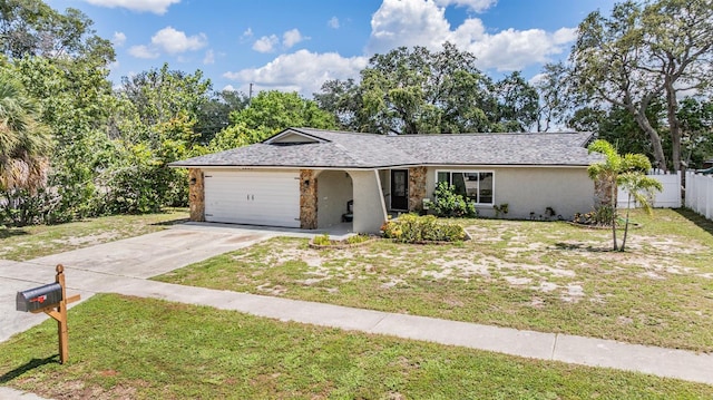 1403 Tallahassee Dr, Tarpon Springs, FL 34689 - ranch-style home with a garage, driveway, stucco siding, and stone siding