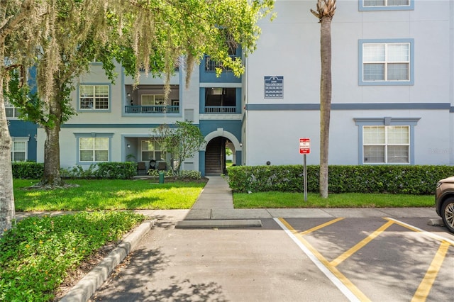 1640 Villa Capri Cir Unit 206, Odessa, FL 33556 - view of front of property with stucco siding and uncovered parking