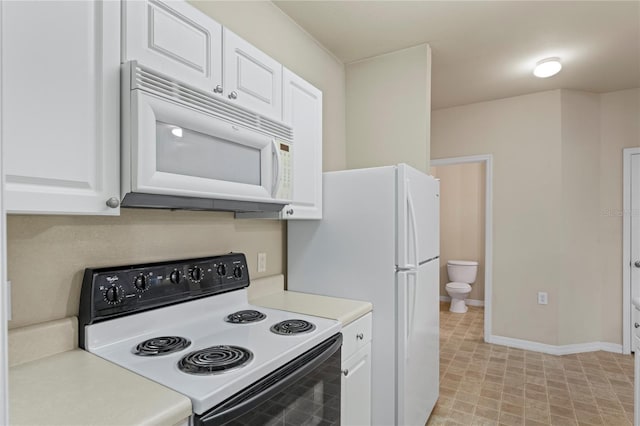 1640 Villa Capri Cir Unit 206, Odessa, FL 33556 - kitchen featuring electric range, white microwave, white cabinetry, and light countertops