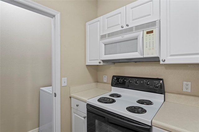 1640 Villa Capri Cir Unit 206, Odessa, FL 33556 - kitchen with white microwave, electric range oven, and white cabinetry