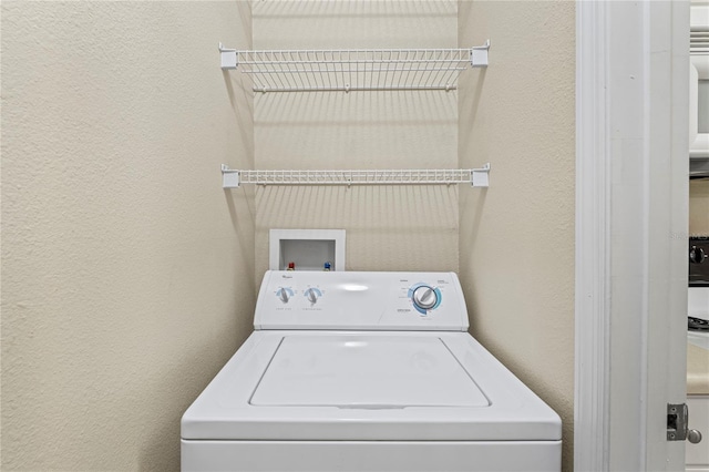 1640 Villa Capri Cir Unit 206, Odessa, FL 33556 - washroom with washer / clothes dryer and a textured wall