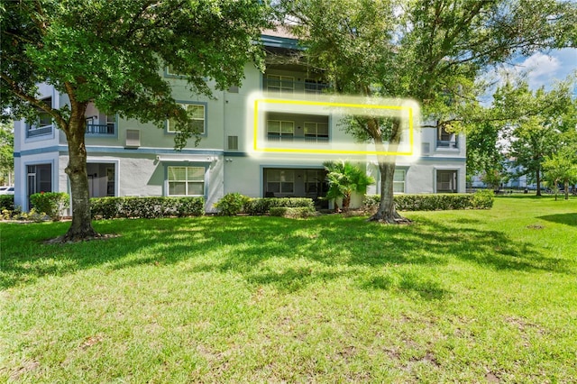 1640 Villa Capri Cir Unit 206, Odessa, FL 33556 - back of house featuring stucco siding and a yard