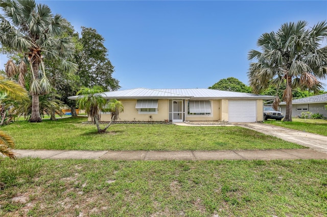 1340 NE Mariposa Dr NE, Palm Bay, FL 32905 - ranch-style house featuring stucco siding, an attached garage, driveway, a front lawn, and a metal roof